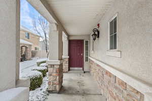 Property entrance with stucco siding and stone siding
