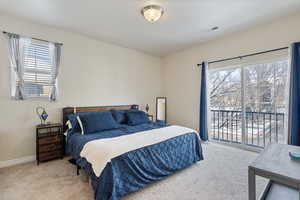 Primary Bedroom featuring multiple windows, carpeted floors