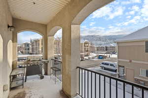 Balcony featuring a mountain view and grilling area