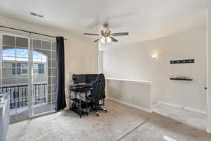 Office space featuring carpet and ceiling fan
