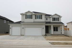 View of front facade featuring a porch, central AC, a shingled roof, concrete driveway, and a garage