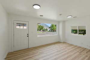 Foyer entrance featuring baseboards and light wood-style floors
