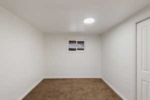 Carpeted empty room with baseboards