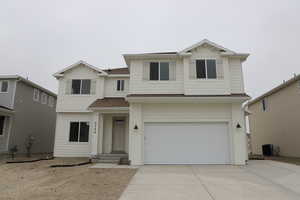 View of front of property with central AC, concrete driveway, a garage, and roof with shingles