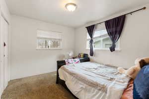 Carpeted bedroom featuring baseboards
