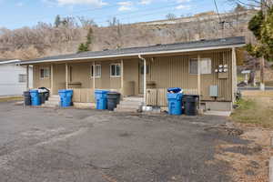 Rear view of property featuring roof with shingles