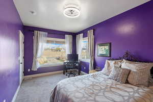 Carpeted bedroom featuring baseboards