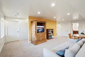 Living room featuring light carpet, recessed lighting, and baseboards