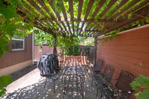 View of patio / terrace featuring outdoor dining area, a pergola, and area for grilling