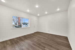 Spare room with dark wood-style floors and recessed lighting