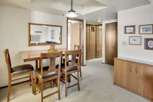 Dining space with light colored carpet