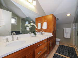 Full bath with vaulted ceiling, double vanity,