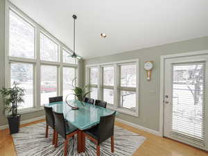 Dining area with recessed lighting, lvaulted ceiling, views of the world and access to deck