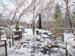 Snow covered patio with a balcony