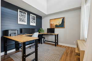 Home office featuring baseboards and wood finished floors