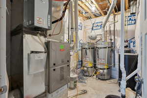 Utility room featuring strapped water heater