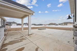 View of patio / terrace featuring fence and a residential view