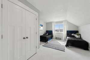 Carpeted bedroom featuring recessed lighting and lofted ceiling