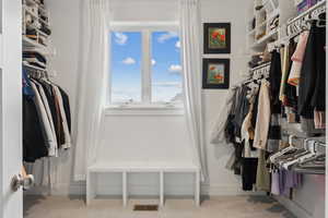 Walk in closet with visible vents and carpet flooring