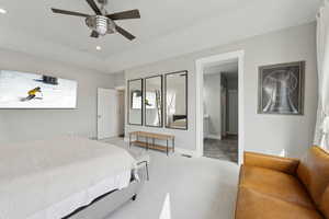 Bedroom featuring light carpet, ensuite bathroom, recessed lighting, baseboards, and ceiling fan