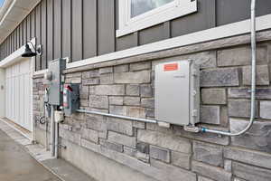 Exterior space featuring stone siding and electric meter