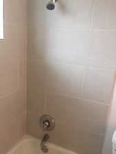 Full bathroom with shower / washtub combination and toilet