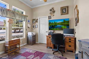 Office featuring a ceiling fan, crown molding, wood finished floors, and baseboards