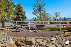 View of yard featuring a mountain view and fence
