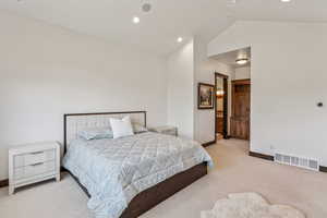 Bedroom with carpet, vaulted ceiling, and recessed lighting