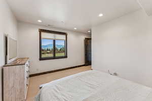Carpeted bedroom featuring recessed lighting and baseboards
