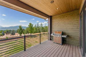 Wooden deck with a grill and a mountain view