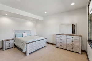Bedroom featuring light carpet and recessed lighting