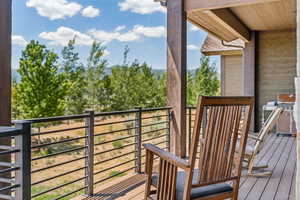 Wooden deck featuring a grill