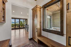 Hallway featuring recessed lighting, dark wood-style flooring, and a mountain view