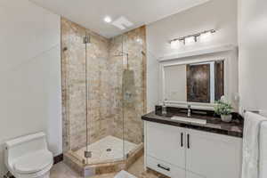 Full bath with a stall shower and vanity