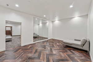 Living area featuring recessed lighting and stairs