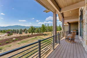 Deck with a mountain view and a grill