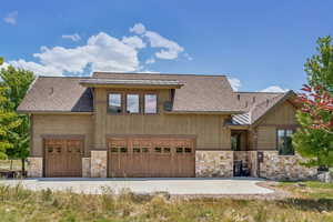 Chalet / cabin with stone siding and roof with shingles