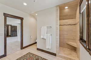 Bathroom with walk in shower and recessed lighting