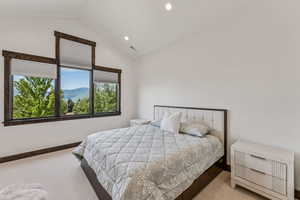 Bedroom with carpet floors, recessed lighting, and high vaulted ceiling