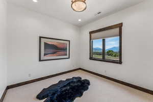 Spare room with light colored carpet, recessed lighting, and a mountain view