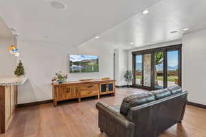 Living area featuring light wood-style floors and recessed lighting