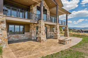 Patio / terrace with an outdoor fire pit, a mountain view, and a patio