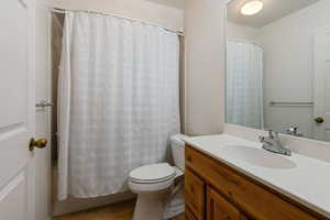 Bathroom with vanity, toilet, and tile patterned flooring