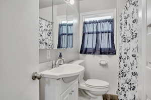 Full bathroom featuring vanity, tile walls, and a shower with shower curtain