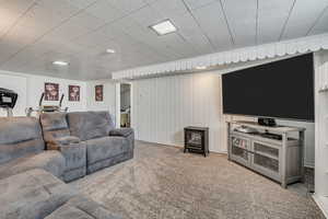 Living room with a wood stove and carpet flooring