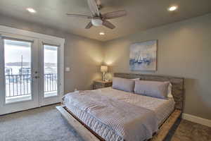 primary bedroom opens to covered deck. Carpeted bedroom with baseboards, recessed lighting, ceiling fan, french doors, and access to outside