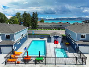 Community pool featuring a mountain view, a residential view, a patio area, and fence