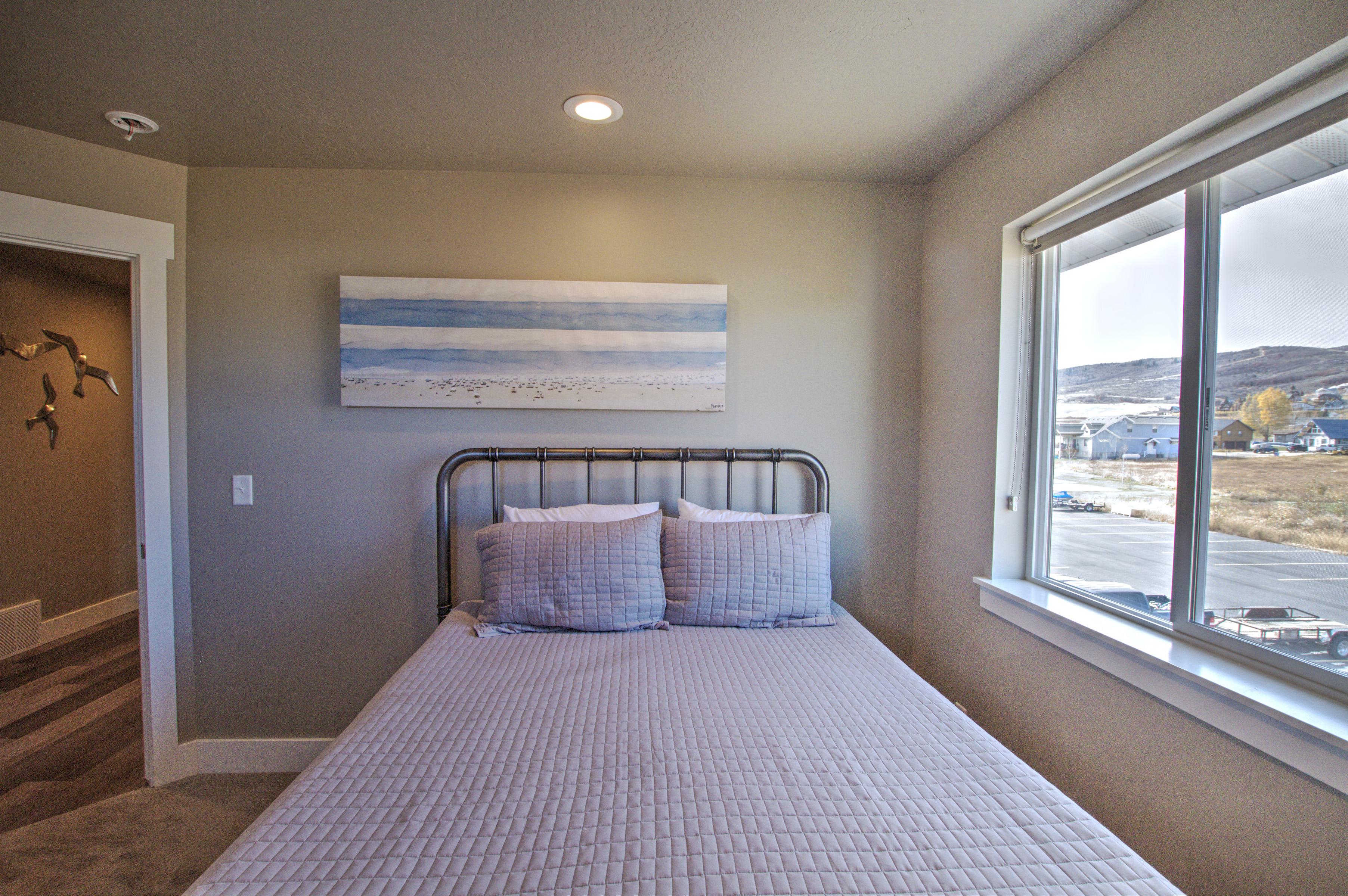 Carpeted bedroom featuring recessed lighting, multiple windows, a mountain view, and baseboards