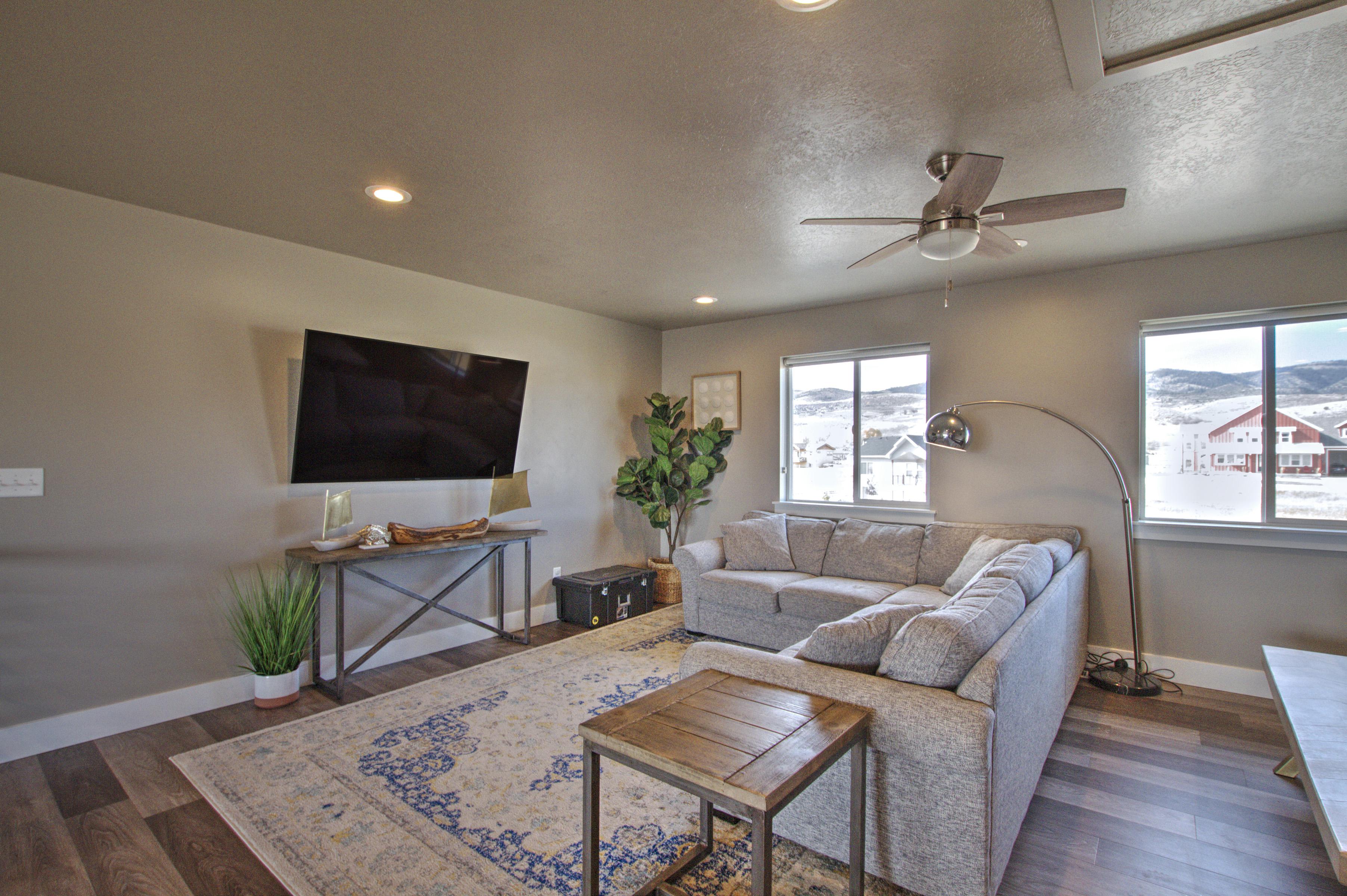 Living area with dark wood finished floors, plenty of natural light, and baseboards
